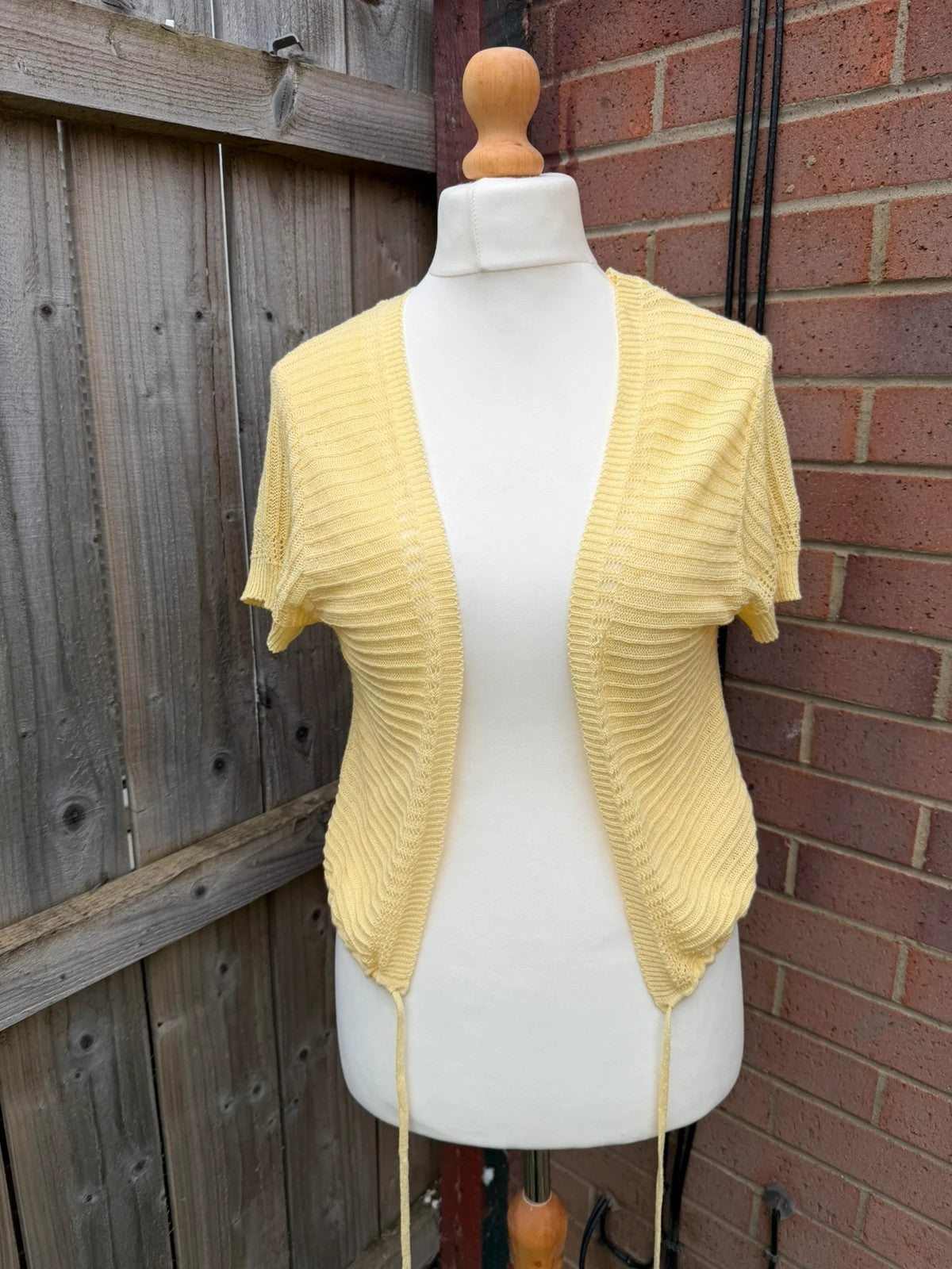 Simply Be yellow knit cropped bolero shrug with tie front detail.