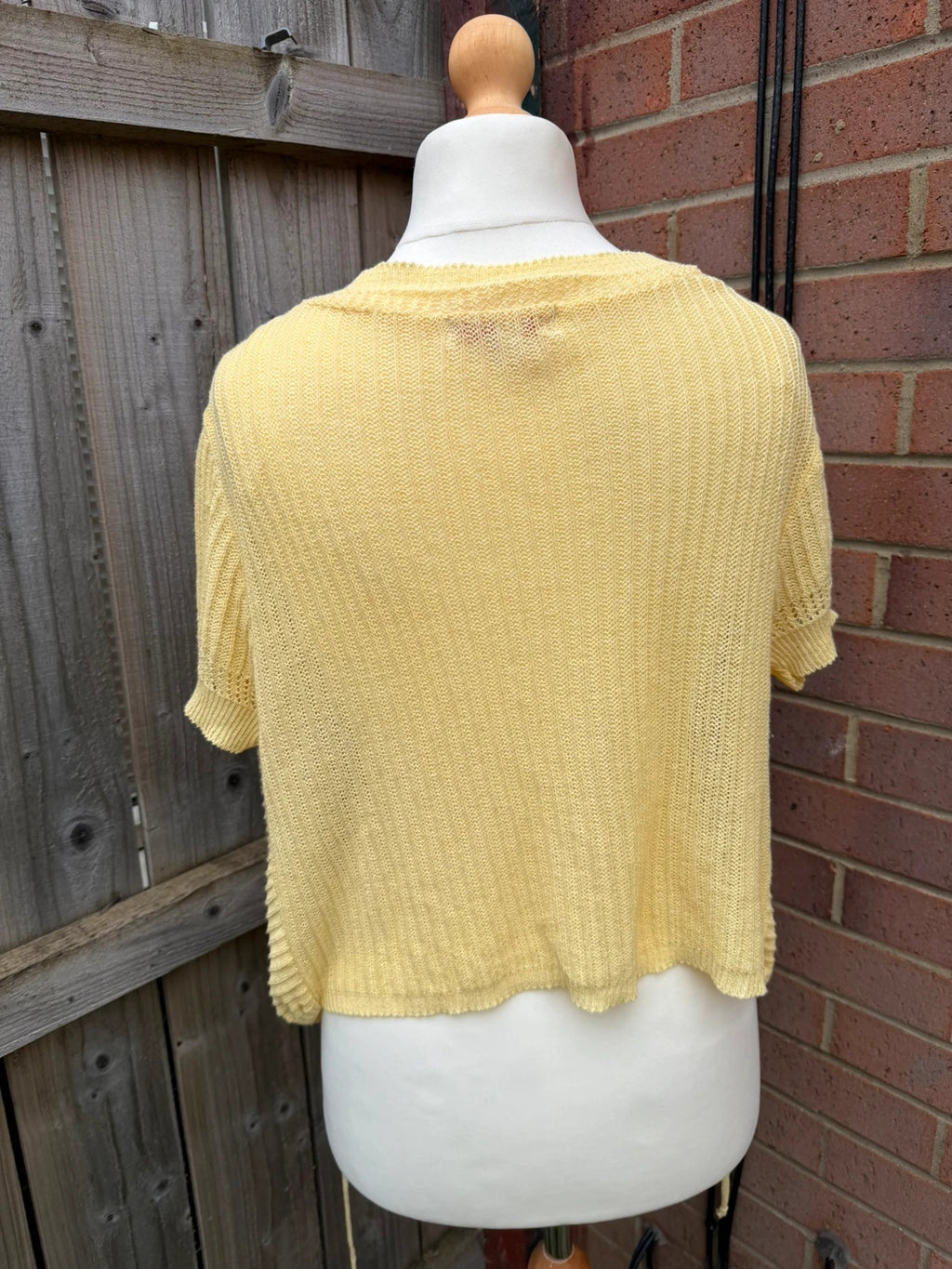 Simply Be yellow knit cropped bolero shrug with tie front detail.