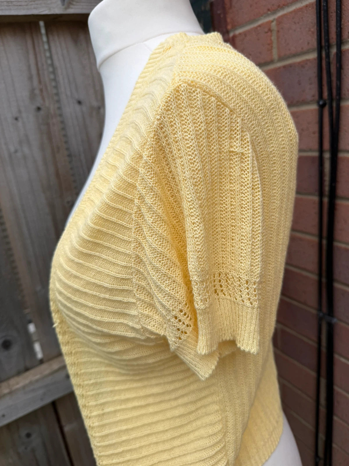 Simply Be yellow knit cropped bolero shrug with tie front detail.