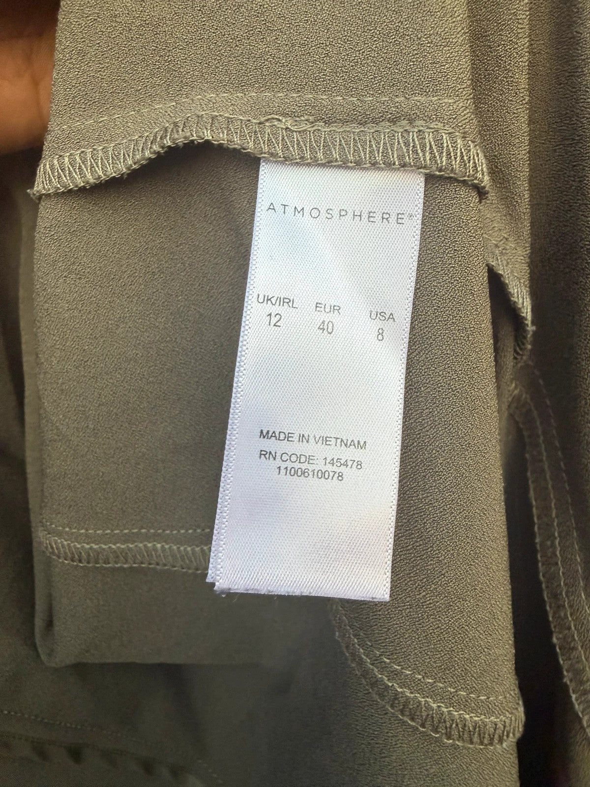 Atmosphere khaki sleeveless blazer with utility pockets and Y2K style details.