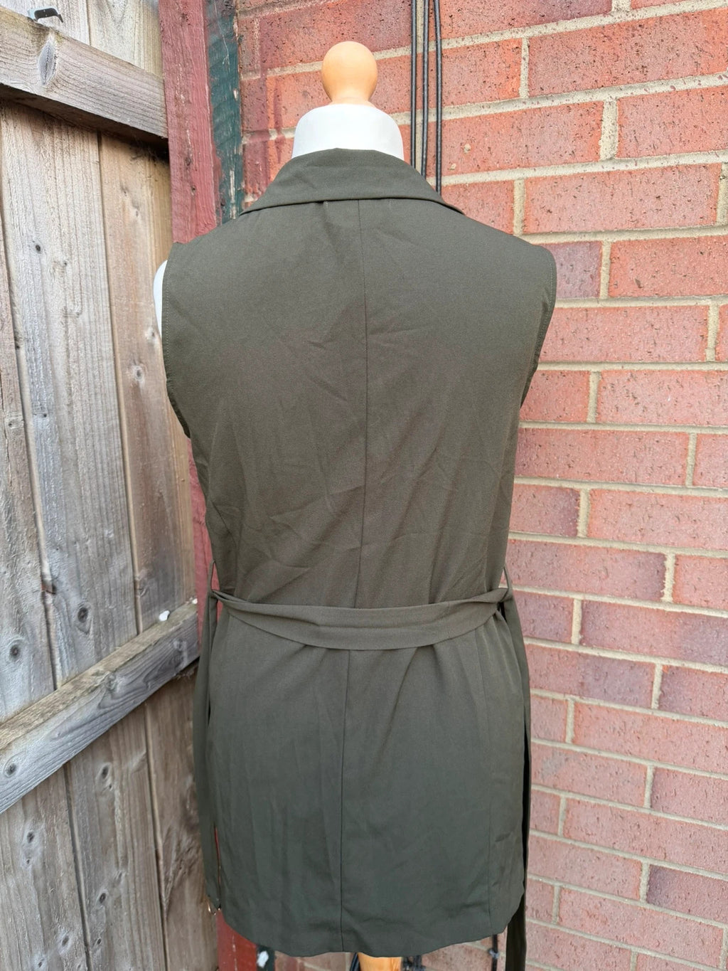 Atmosphere khaki sleeveless blazer with utility pockets and Y2K style details.