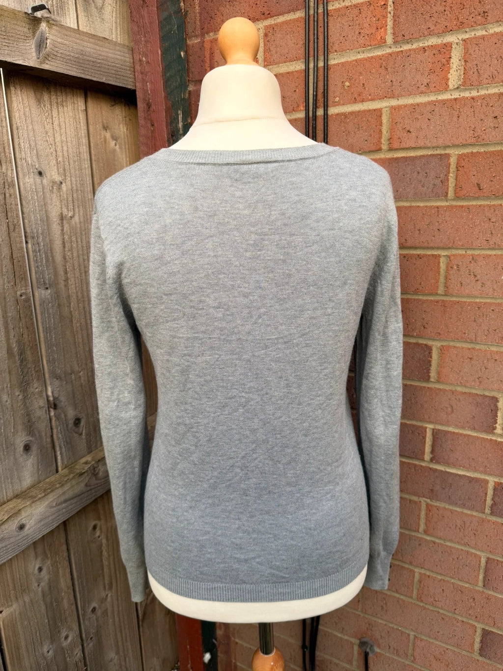 Papaya grey fine knit cardigan with button front and soft texture.