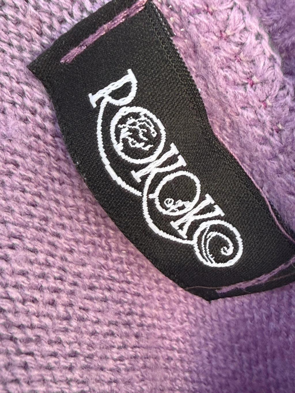 Colour block oversized jumper in pink, yellow, and blue knit with no label.