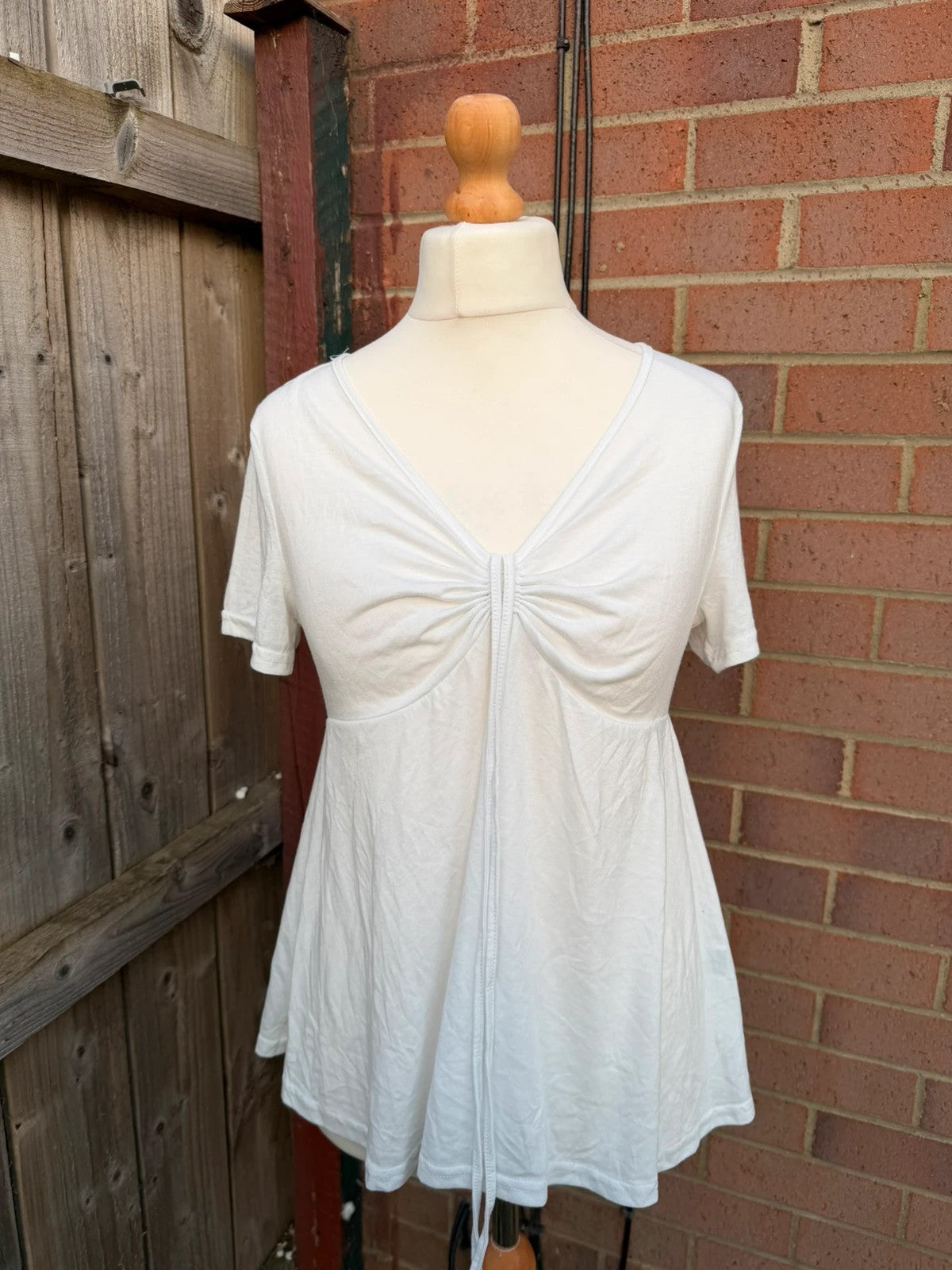 SHEIN white babydoll peplum tunic top with soft fabric and pocket detail.