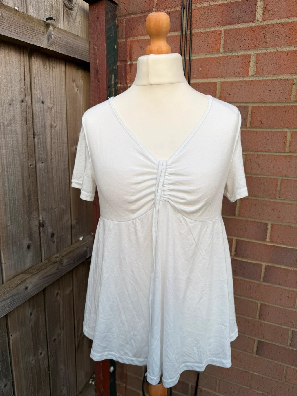 SHEIN white babydoll peplum tunic top with soft fabric and pocket detail.