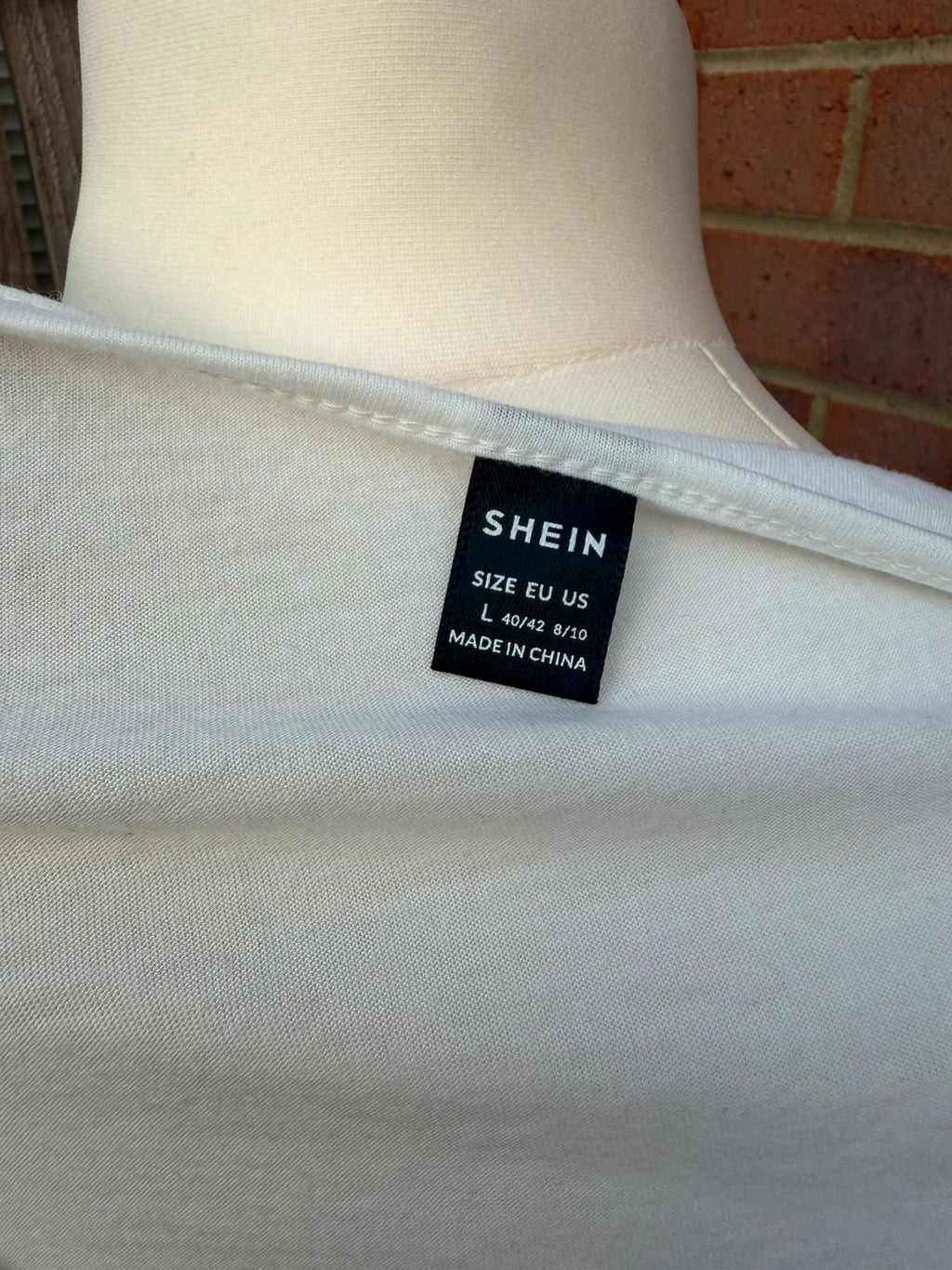 SHEIN white babydoll peplum tunic top with soft fabric and pocket detail.