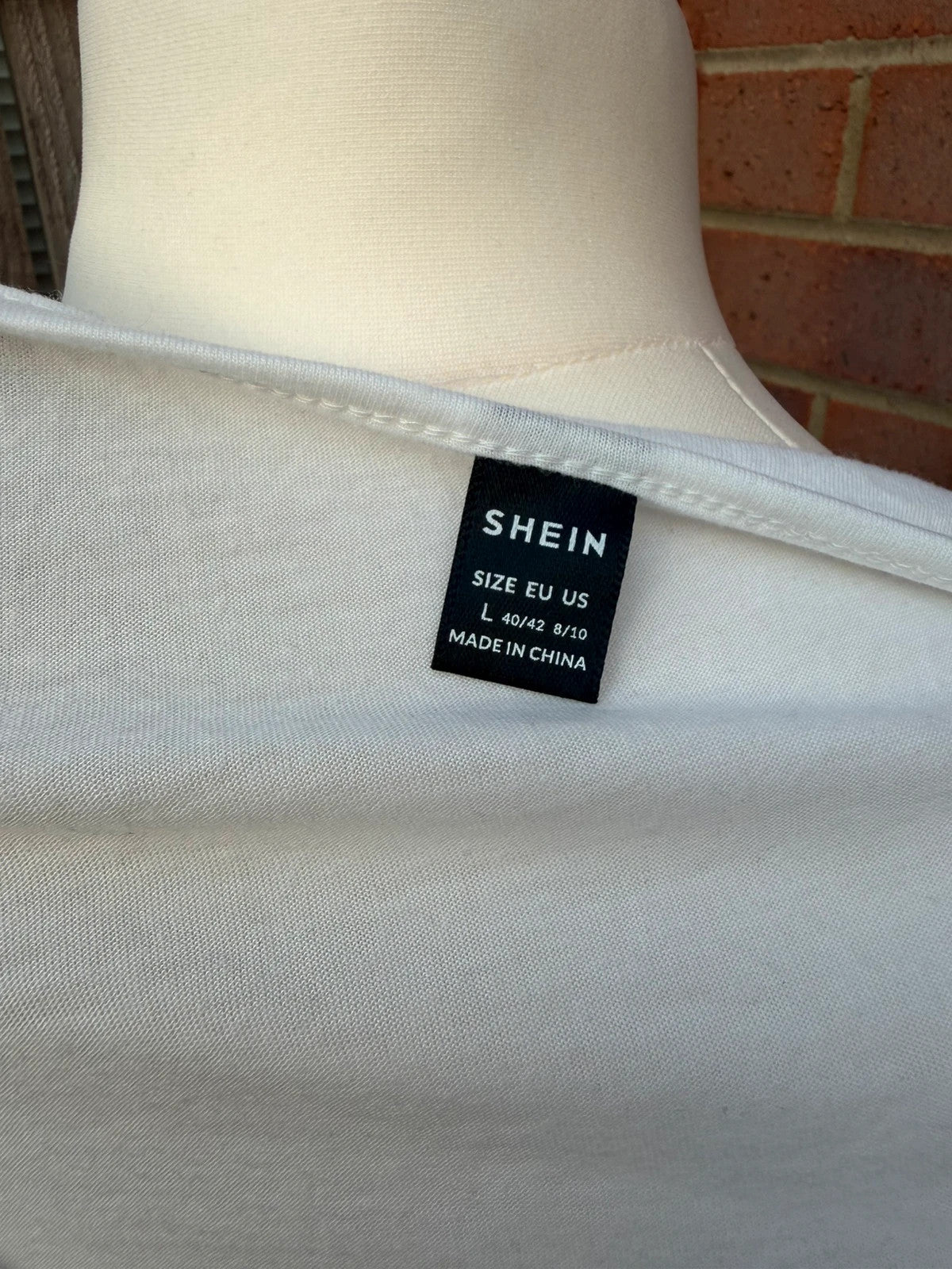 SHEIN white babydoll peplum tunic top with soft fabric and pocket detail.