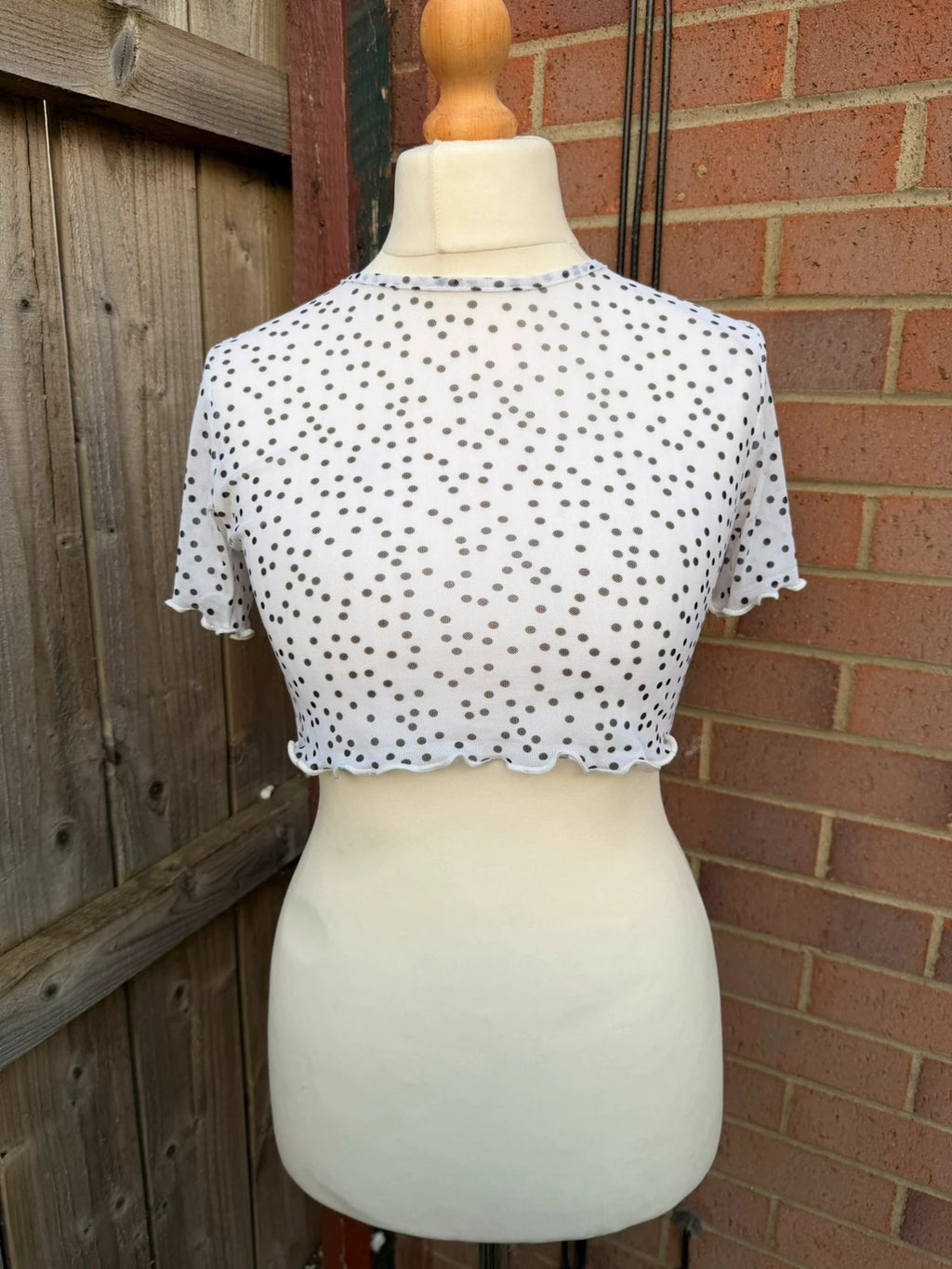 PrettyLittleThing black and white polka dot mesh crop top with coquette fairy style.