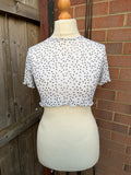 PrettyLittleThing black and white polka dot mesh crop top with coquette fairy style.
