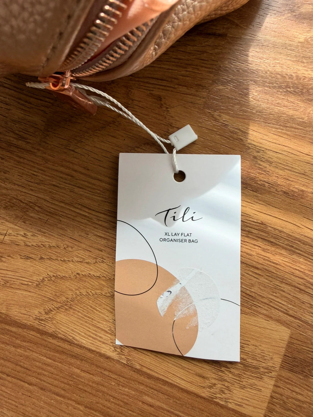 tili pink faux leather wig storage bag with zipper and tag details