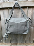 Totes grey leather shoulder bag with minimalist design and new with tags.