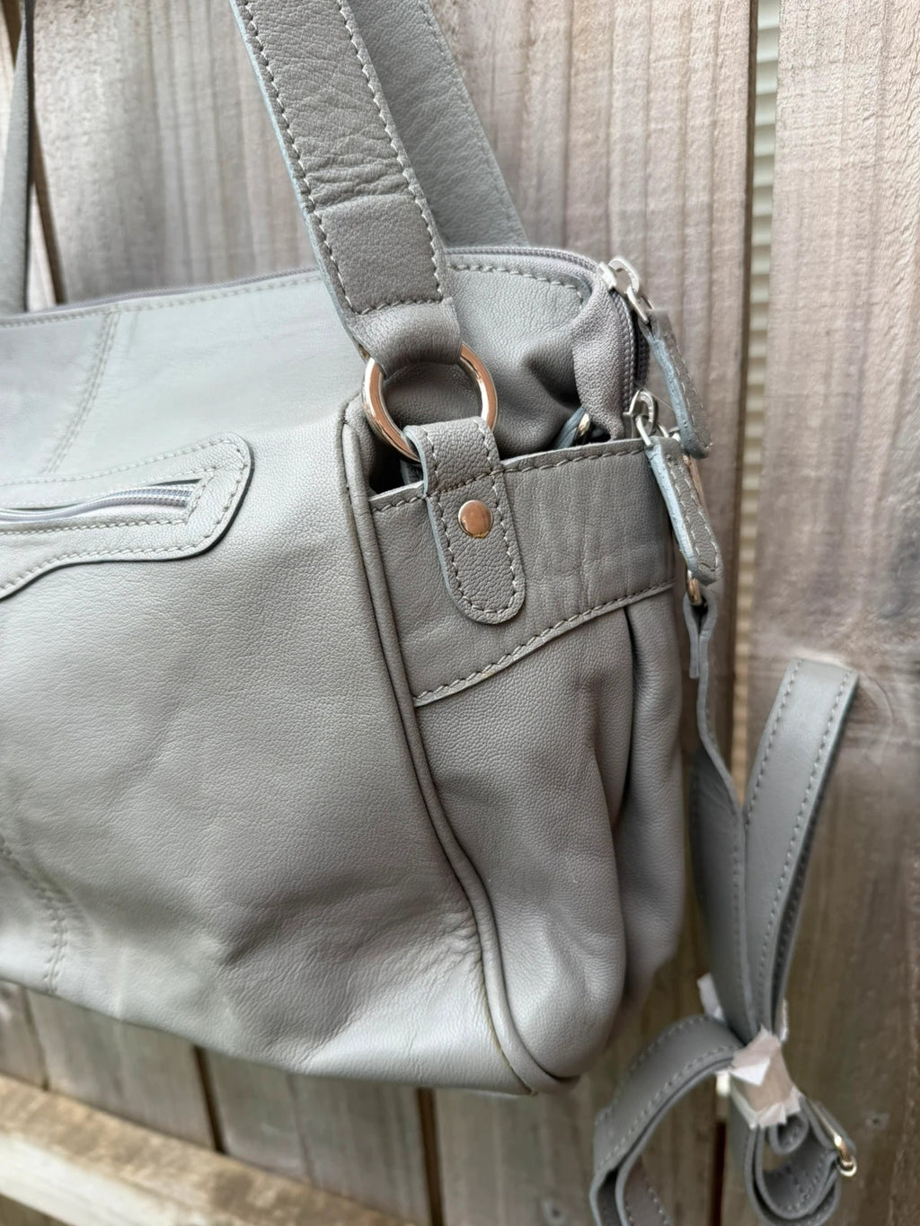 Totes grey leather shoulder bag with minimalist design and new with tags.