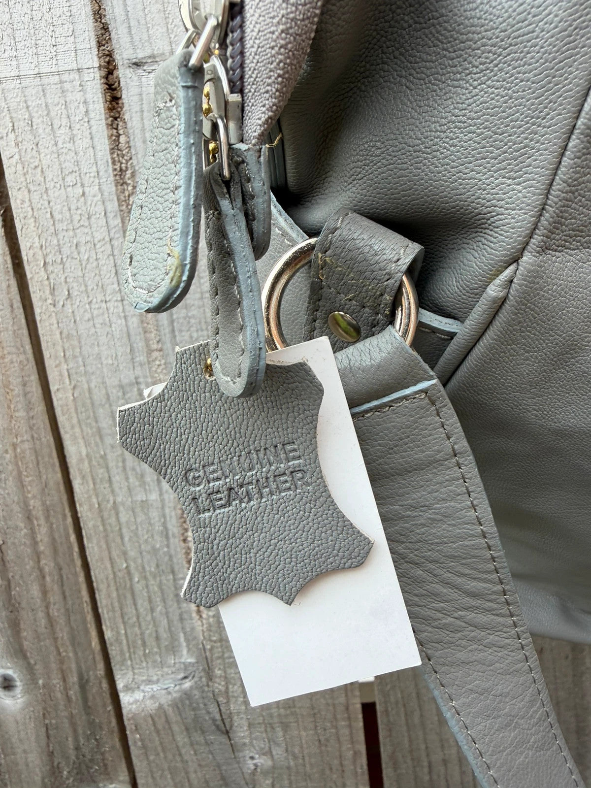Totes grey leather shoulder bag with minimalist design and new with tags.