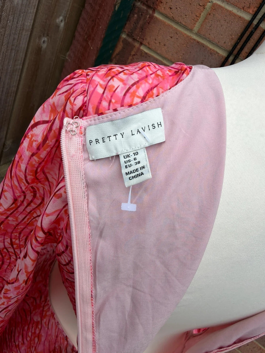 Pretty Lavish pink maxi dress with cut-out details and tiered ruffle design.