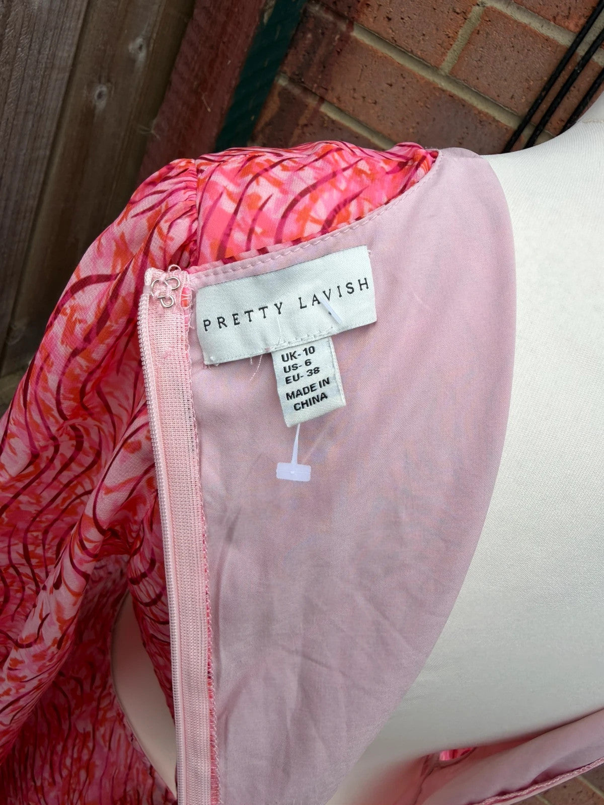 Pretty Lavish pink maxi dress with cut-out details and tiered ruffle design.
