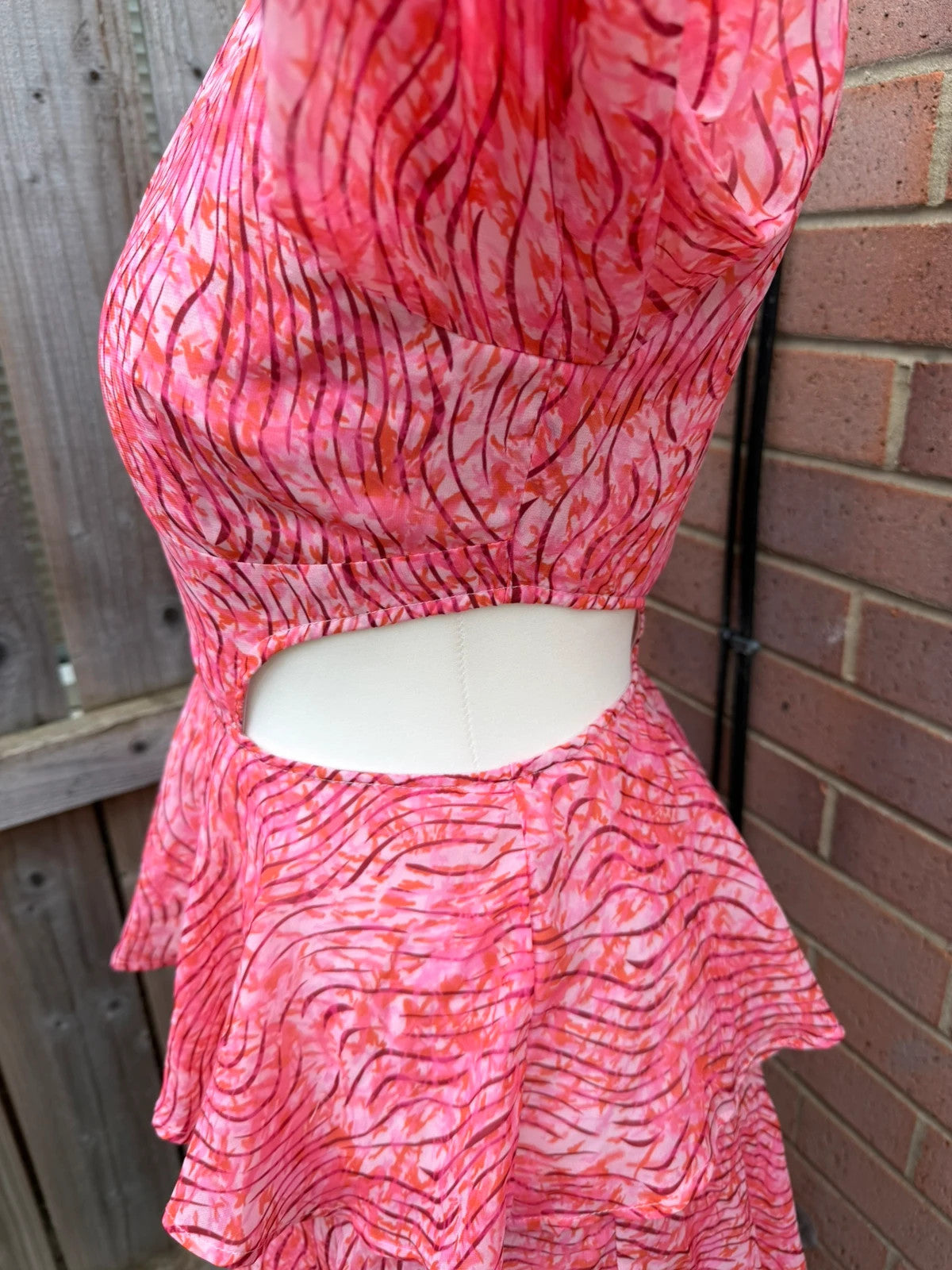 Pretty Lavish pink maxi dress with cut-out details and tiered ruffle design.