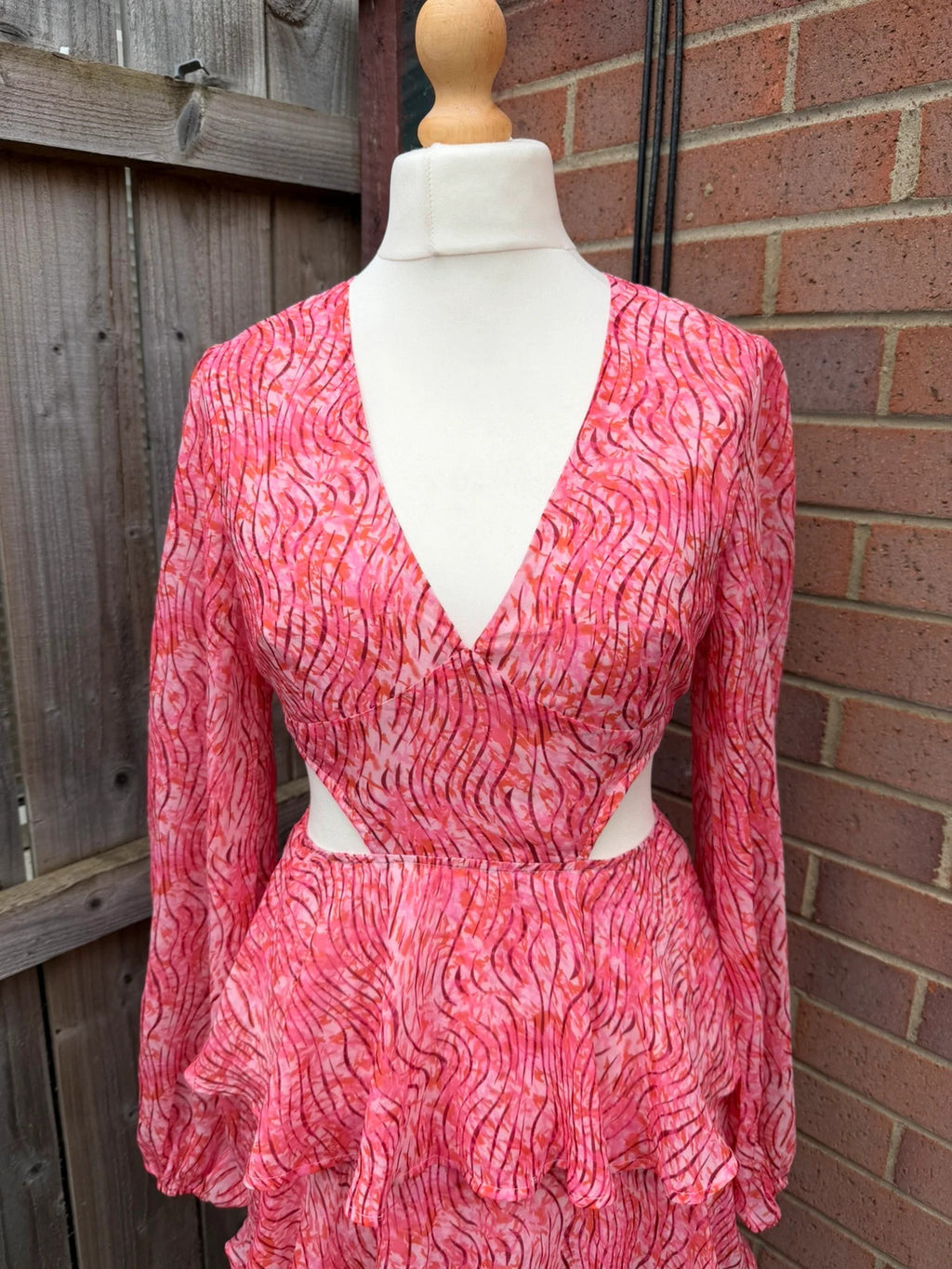 Pretty Lavish pink maxi dress with cut-out details and tiered ruffle design.