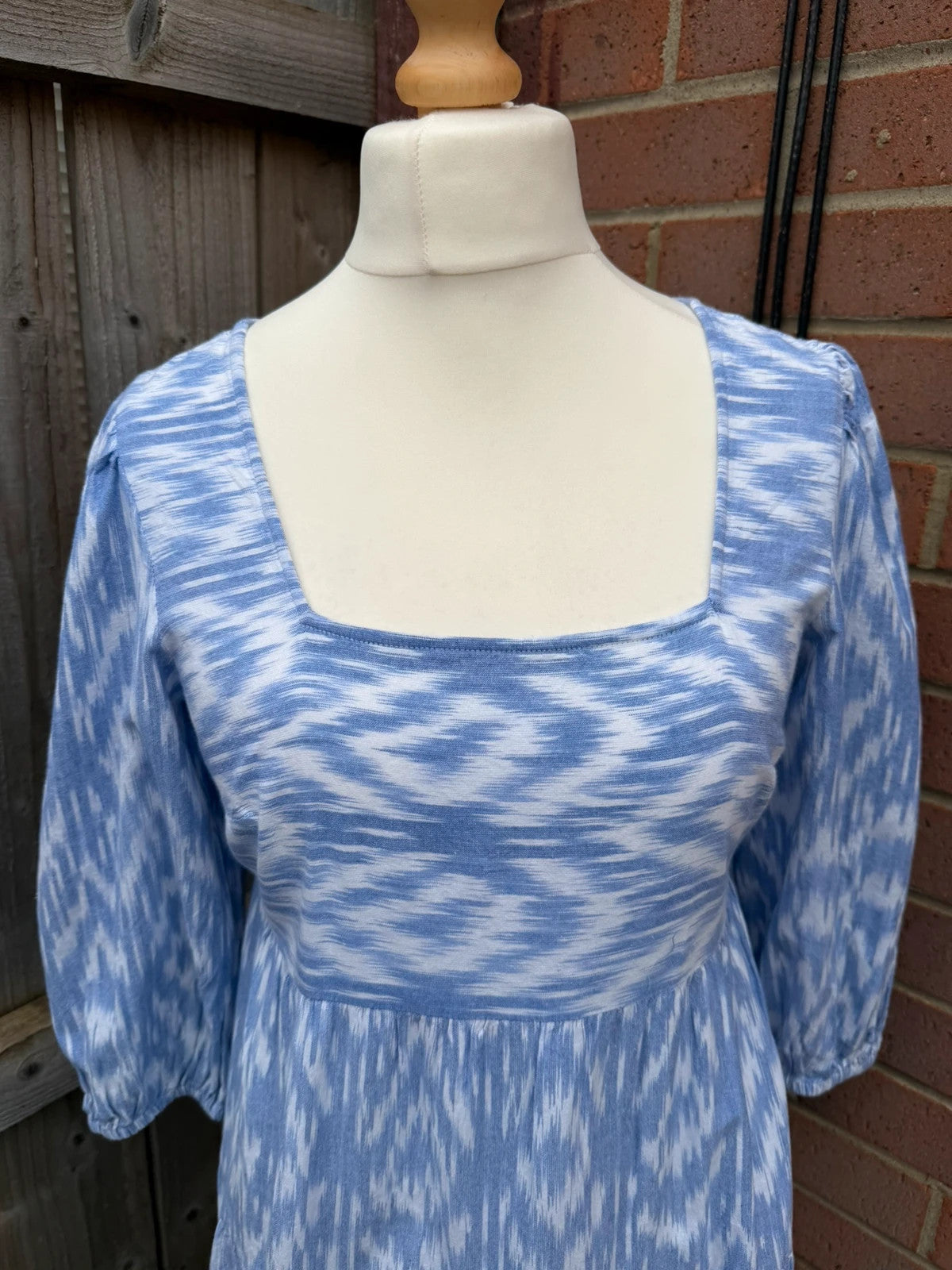 Y2K blue linen smock dress with white abstract print and puff sleeves.