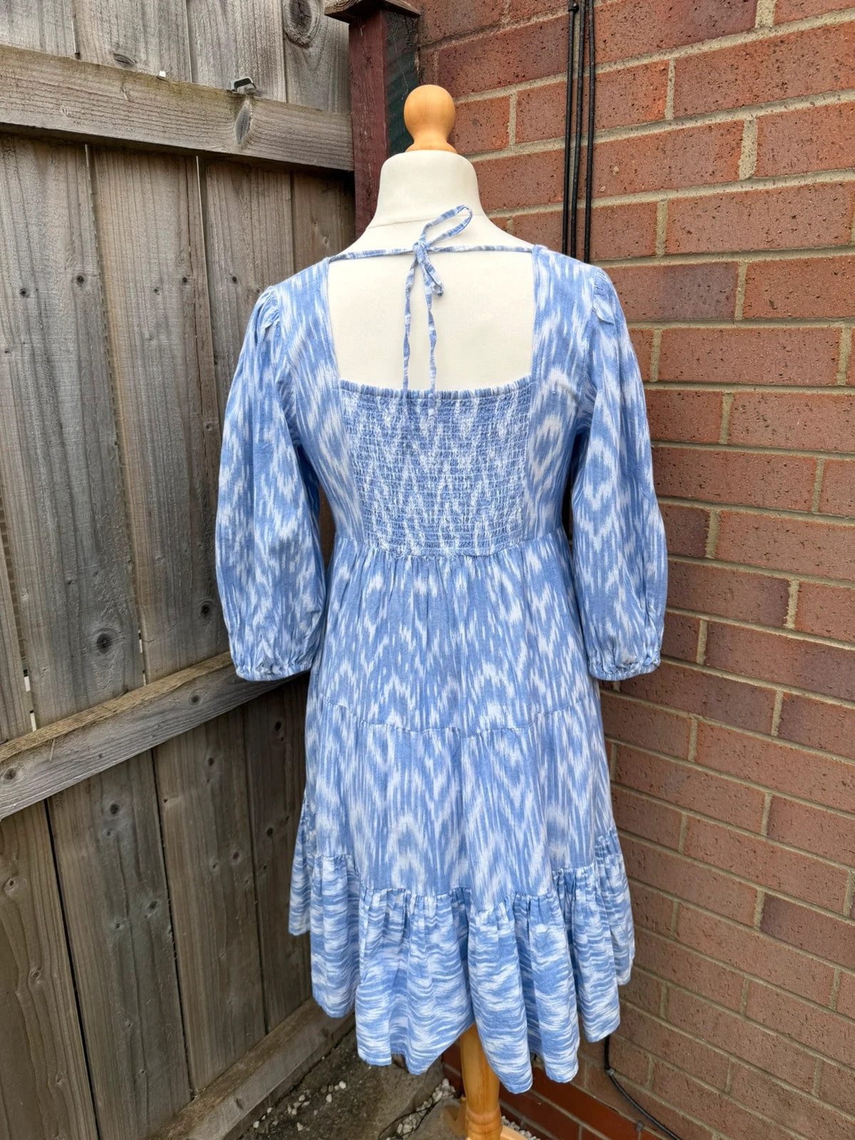 Y2K blue linen smock dress with white abstract print and puff sleeves.