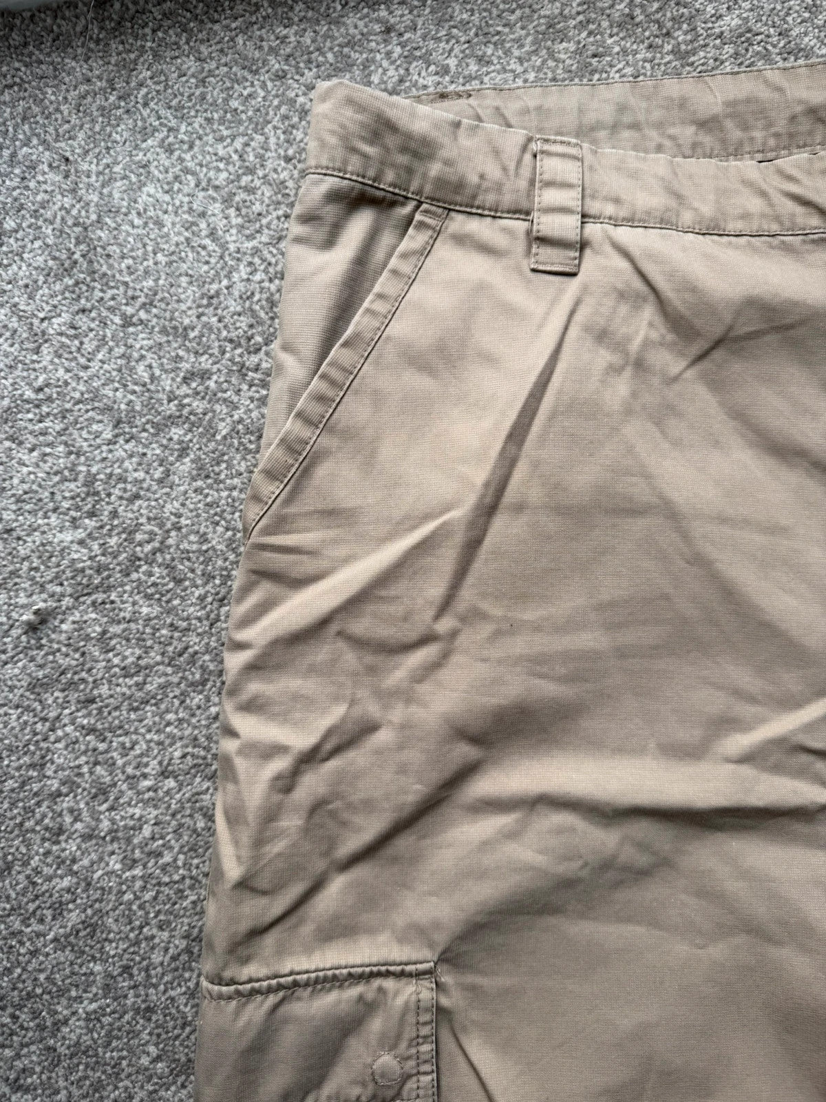 Nike beige cargo shorts with utility pockets and logo detail.