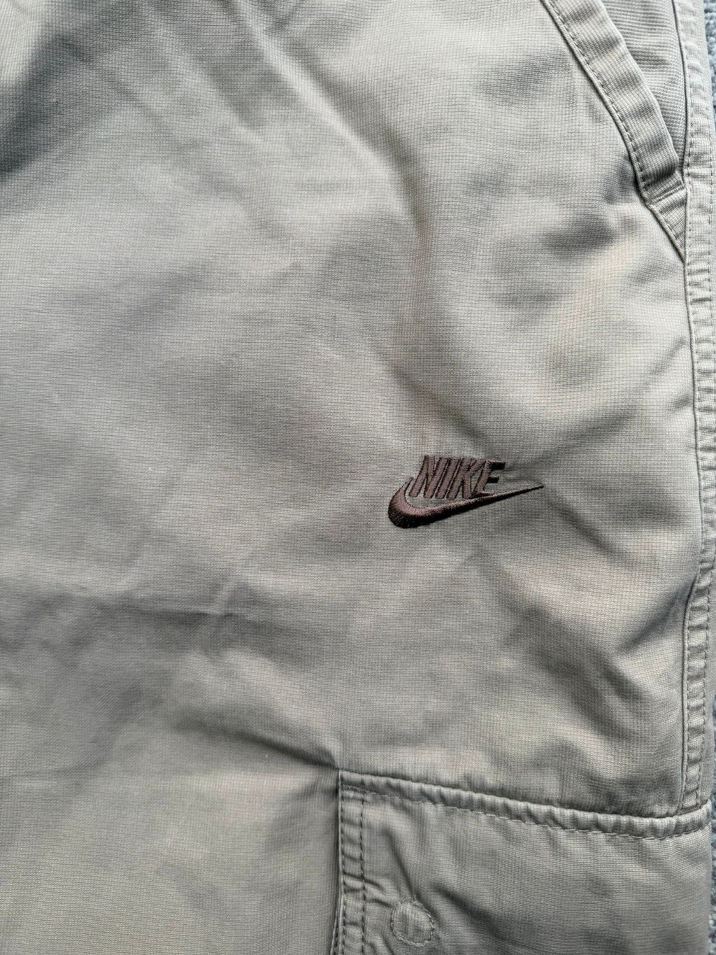 Nike beige cargo shorts with utility pockets and logo detail.