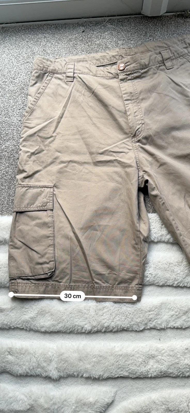 Nike beige cargo shorts with utility pockets and logo detail.