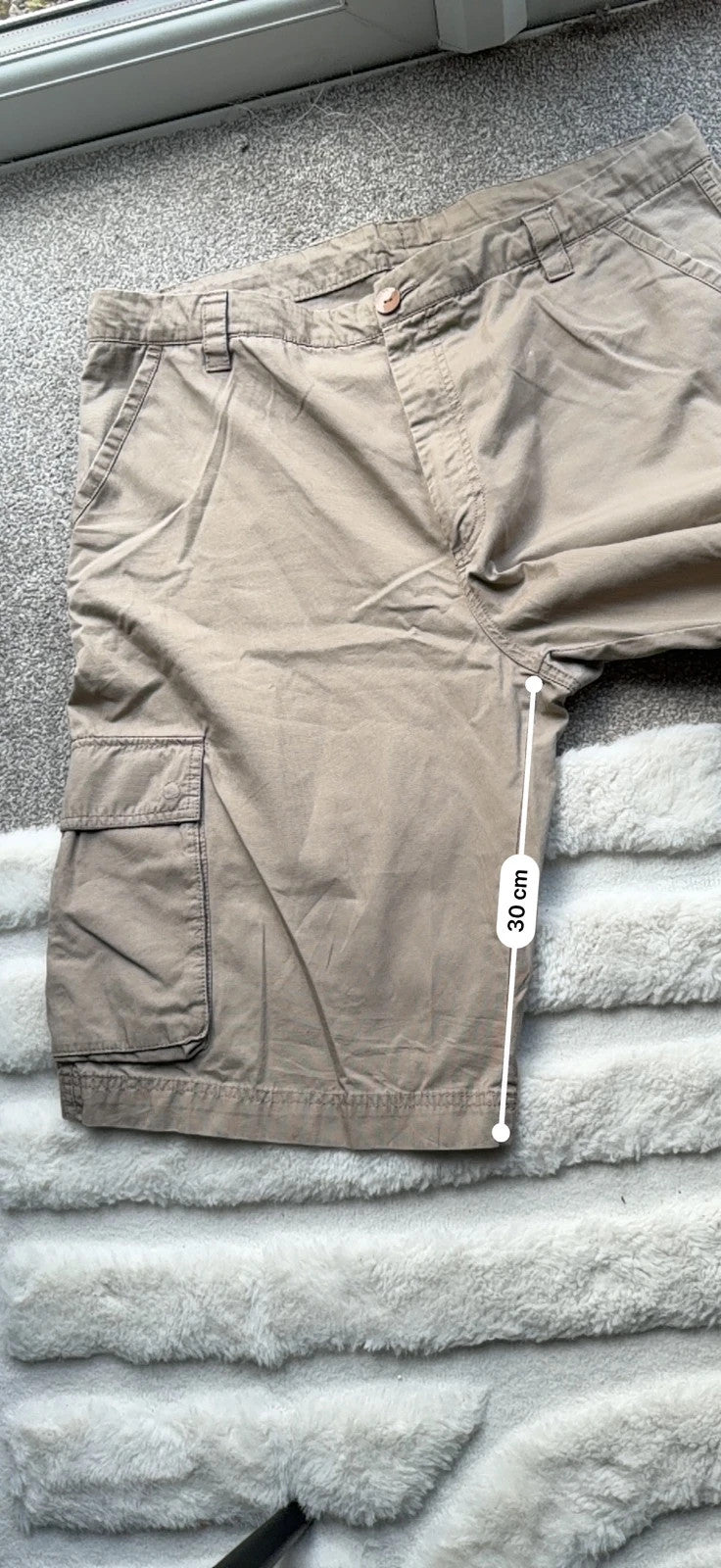 Nike beige cargo shorts with utility pockets and logo detail.