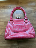 Vintage pink faux crocodile handbag with Y2K style and textured finish.