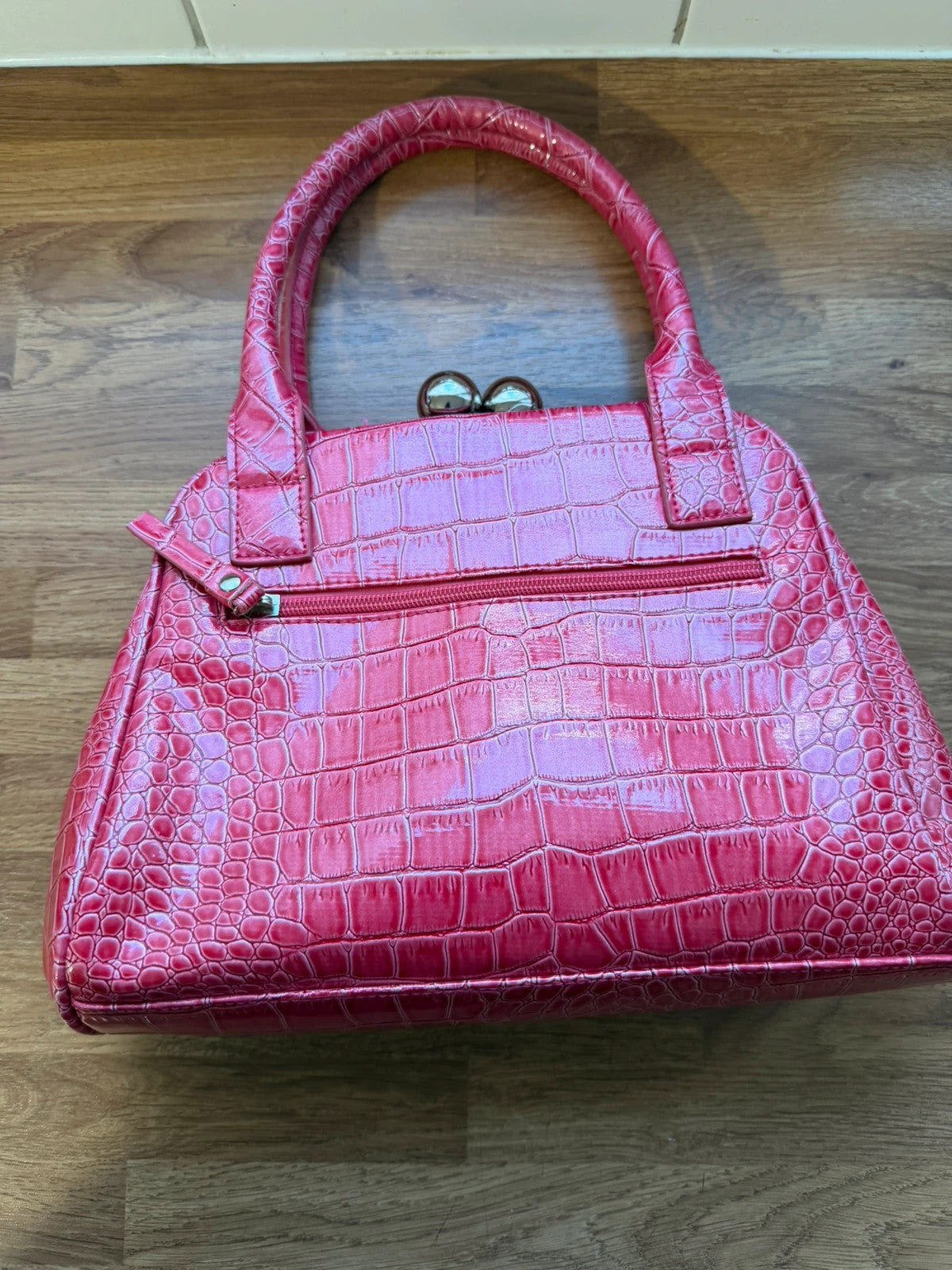 Vintage pink faux crocodile handbag with Y2K style and textured finish.