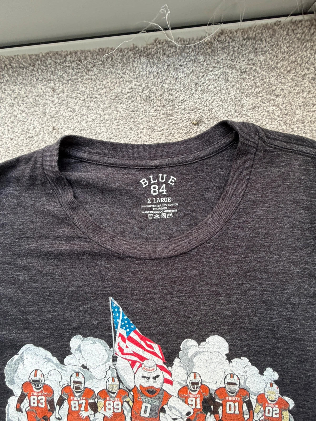 Blue 84 grey graphic tee featuring Miami Hurricanes logo and vintage design.