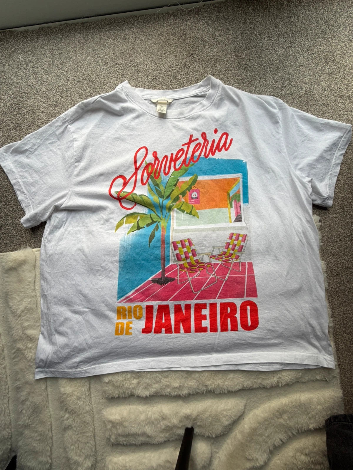 H&M multi graphic tee featuring vintage Brazil tourist print on white fabric.