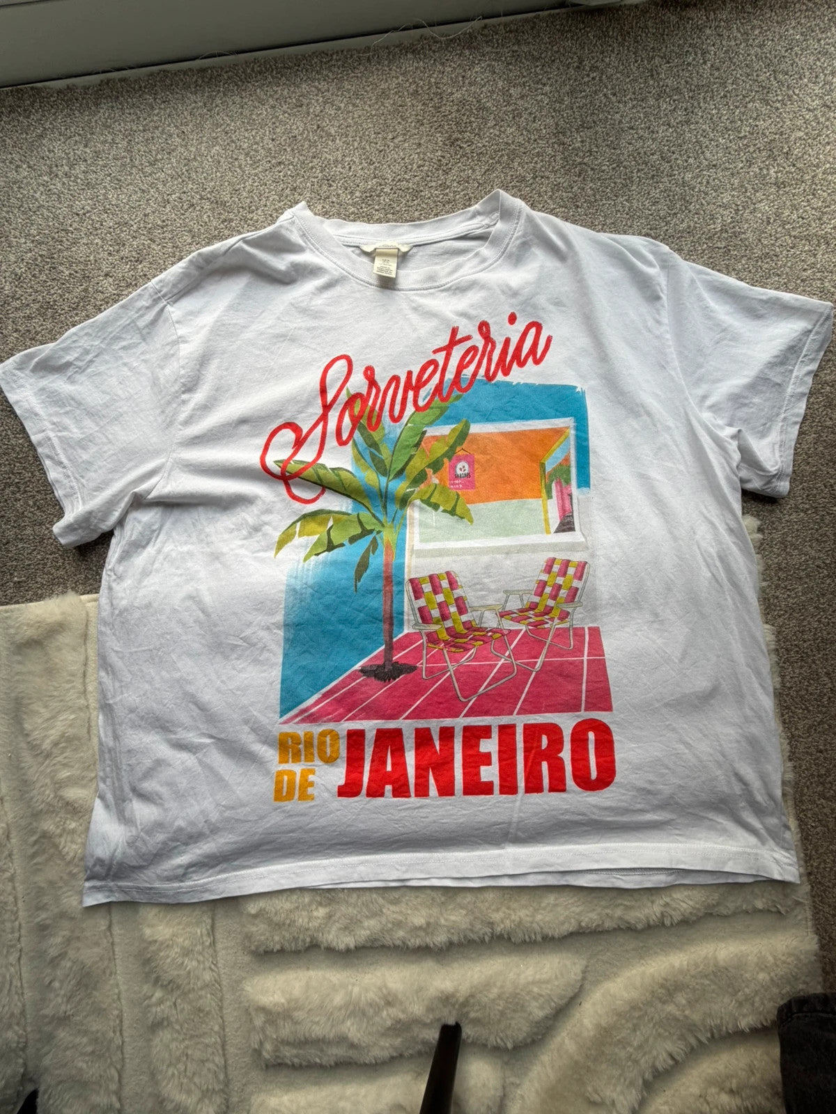 H&M multi graphic tee featuring vintage Brazil tourist print on white fabric.