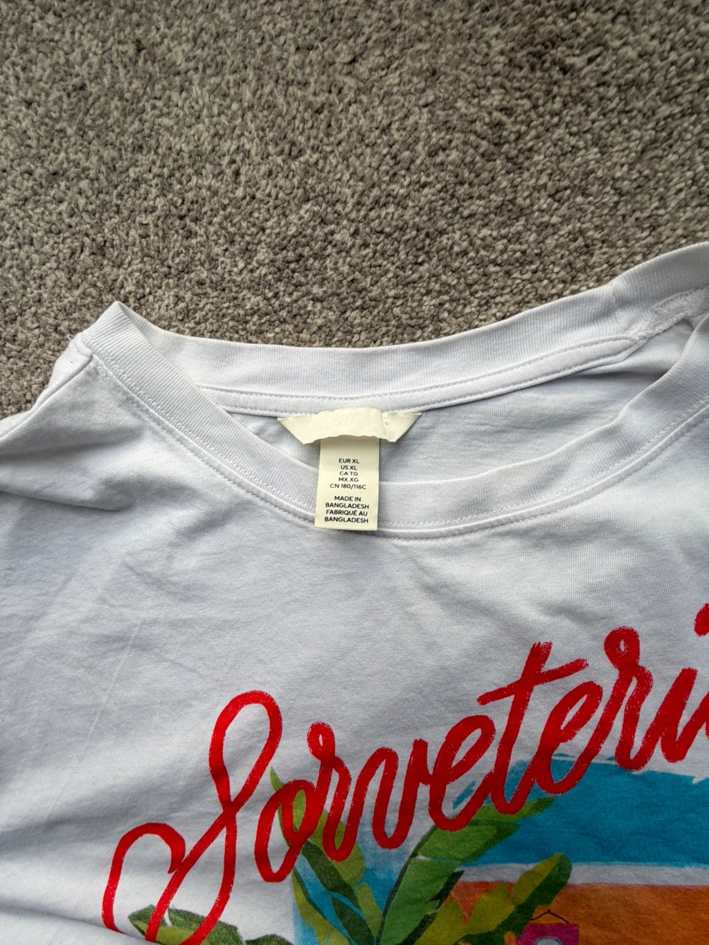 H&M multi graphic tee featuring vintage Brazil tourist print on white fabric.
