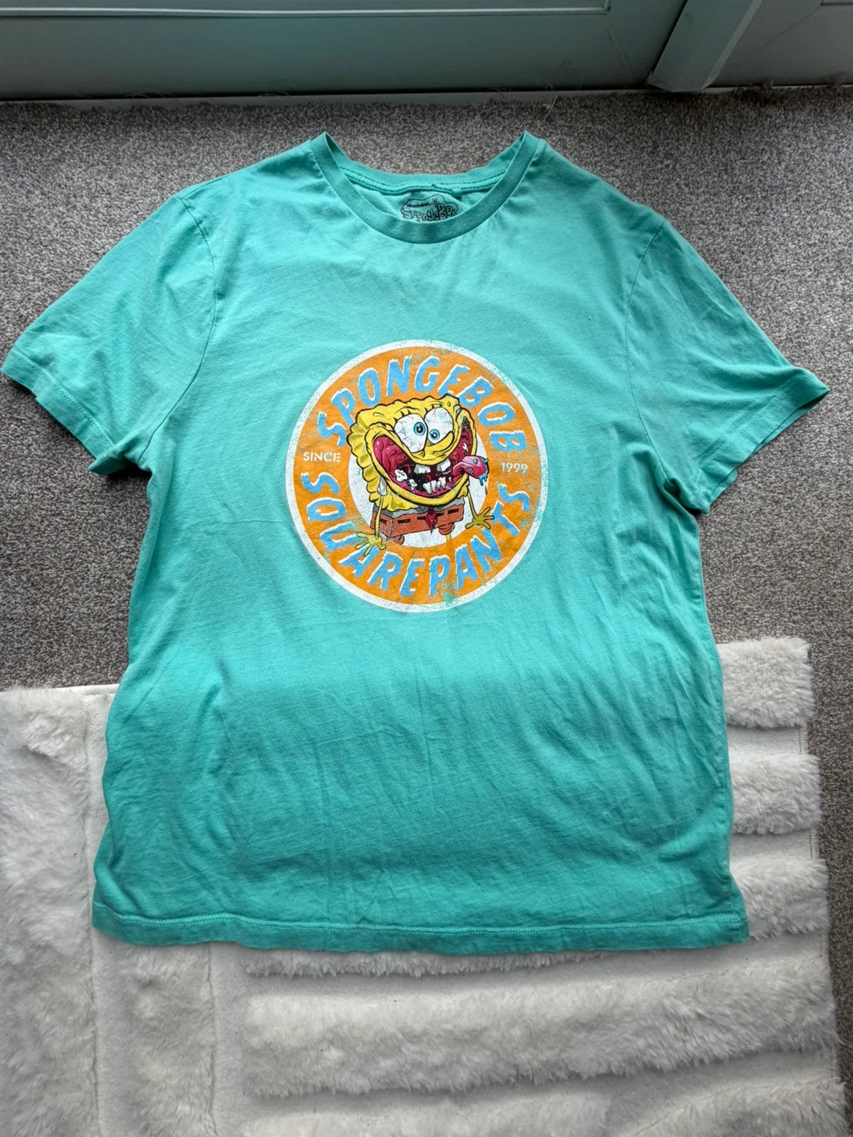 SpongeBob SquarePants blue and green graphic tee featuring cartoon print and vintage Y2K style.