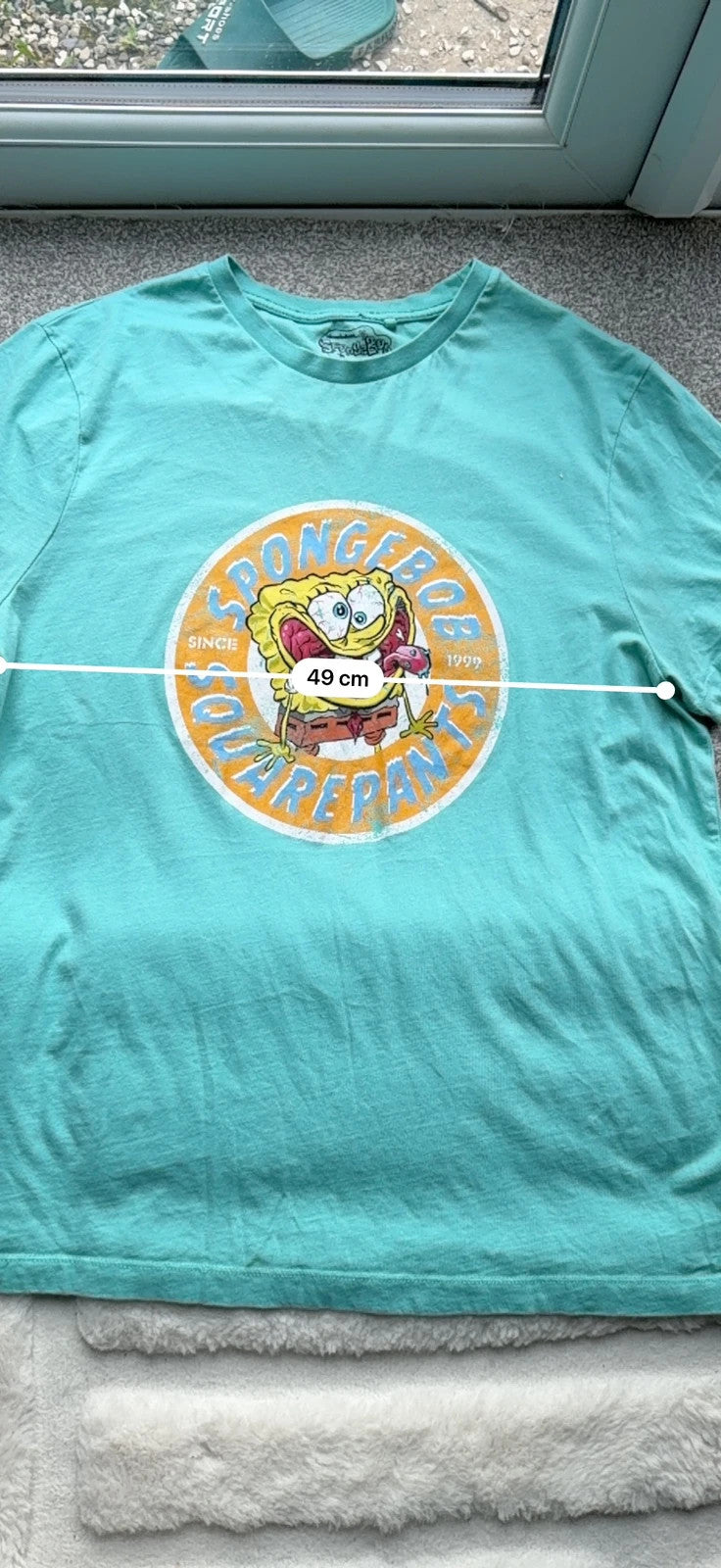 SpongeBob SquarePants blue and green graphic tee featuring cartoon print and vintage Y2K style.