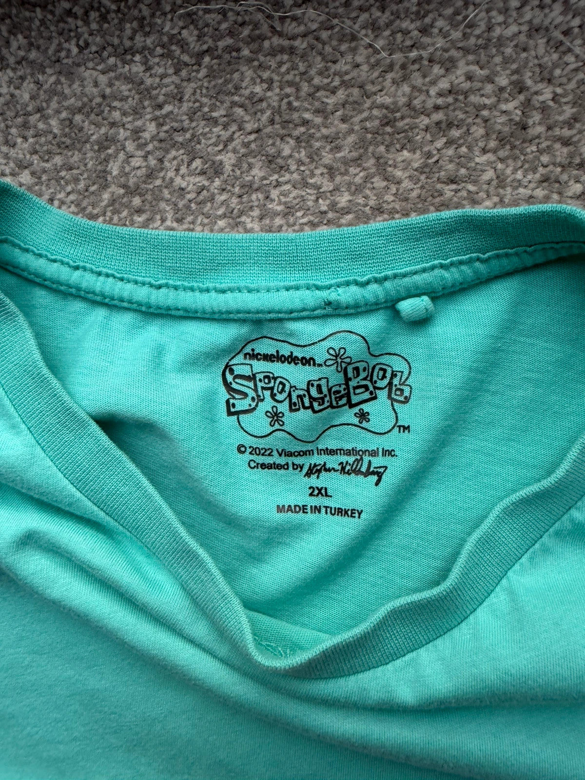 SpongeBob SquarePants blue and green graphic tee featuring cartoon print and vintage Y2K style.