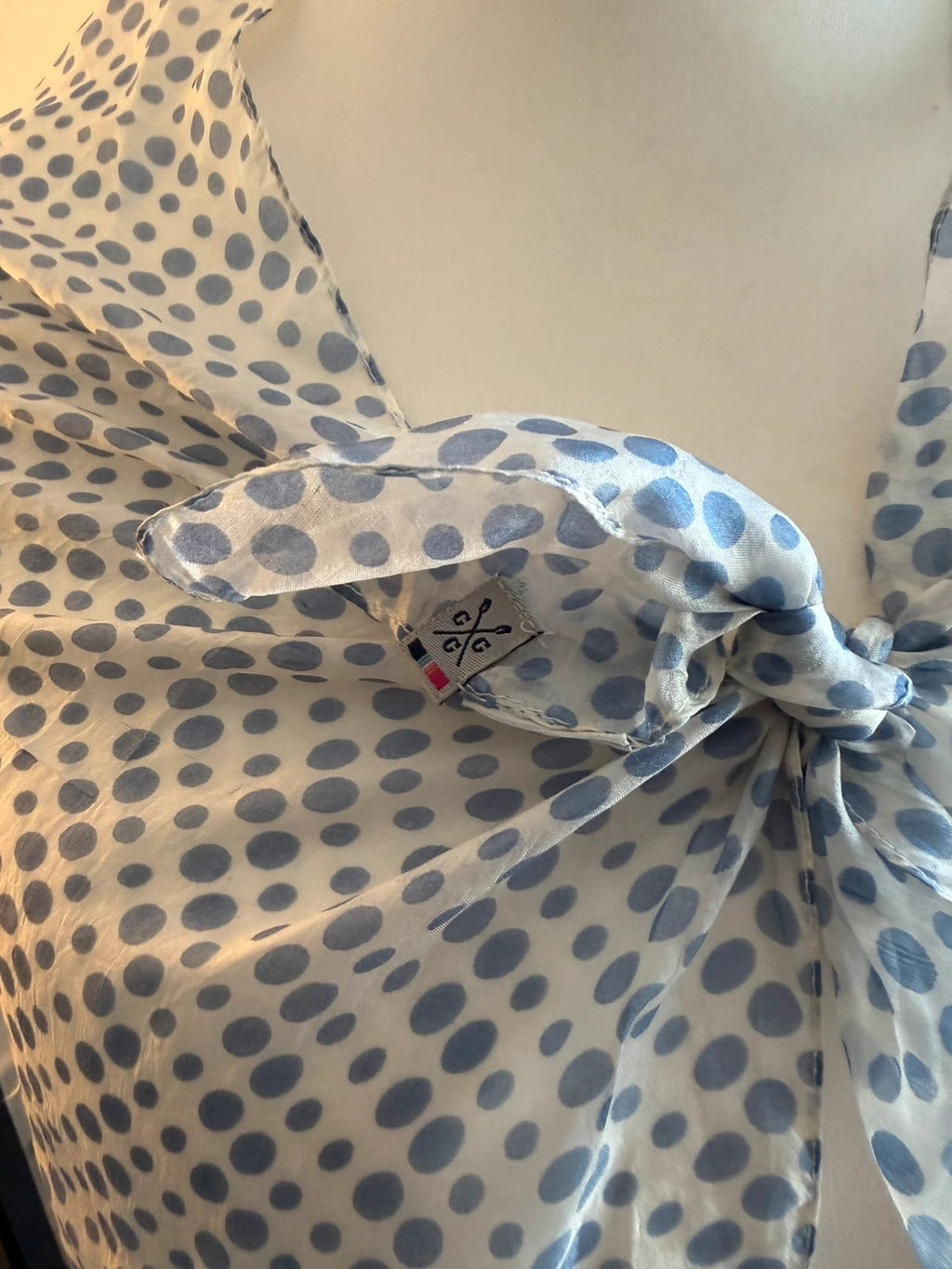 Whites blue and white polka dot lightweight summer scarf with soft fabric.