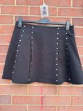 Y2K black mini skirt with stud details, A-line stretch design, pre-loved condition.