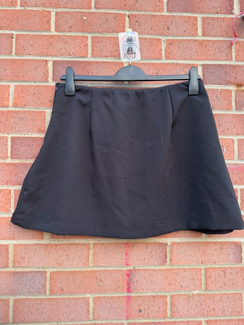 Y2K black mini skirt with stud details, A-line stretch design, pre-loved condition.