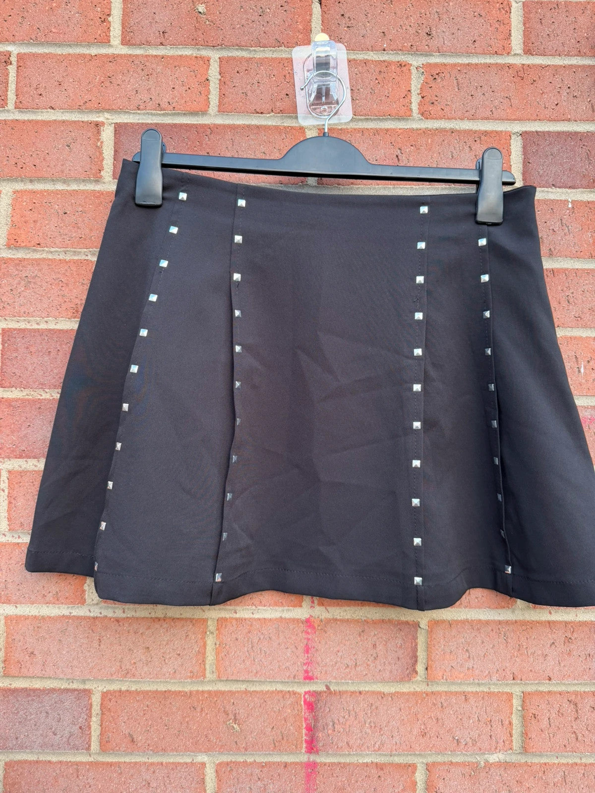 Y2K black mini skirt with stud details, A-line stretch design, pre-loved condition.