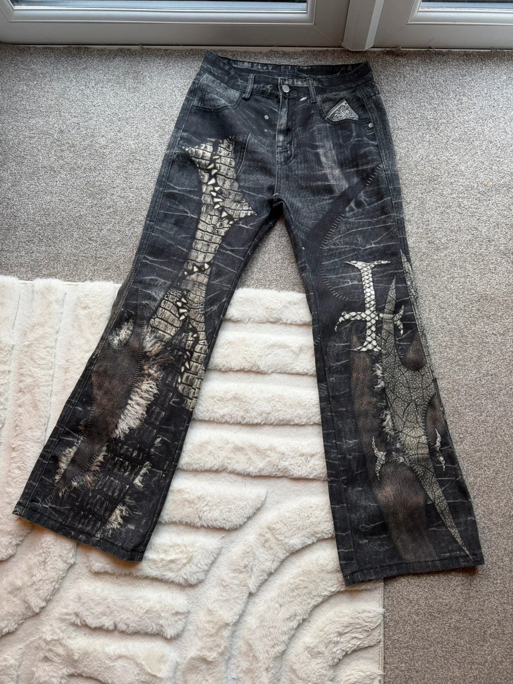 Vintage Denim black straight jeans with grey graphic print and wide leg style.