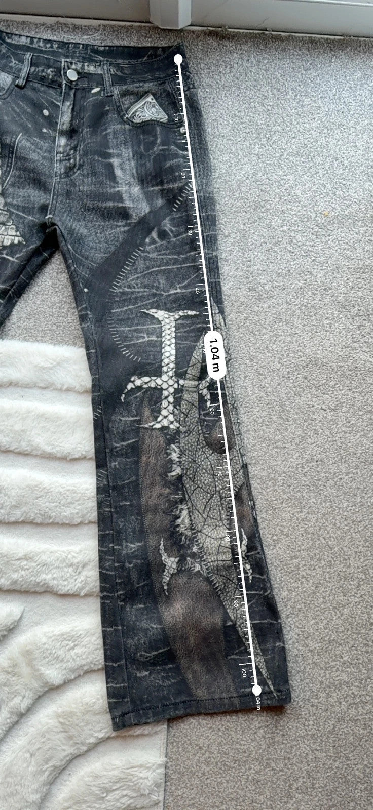 Vintage Denim black straight jeans with grey graphic print and wide leg style.