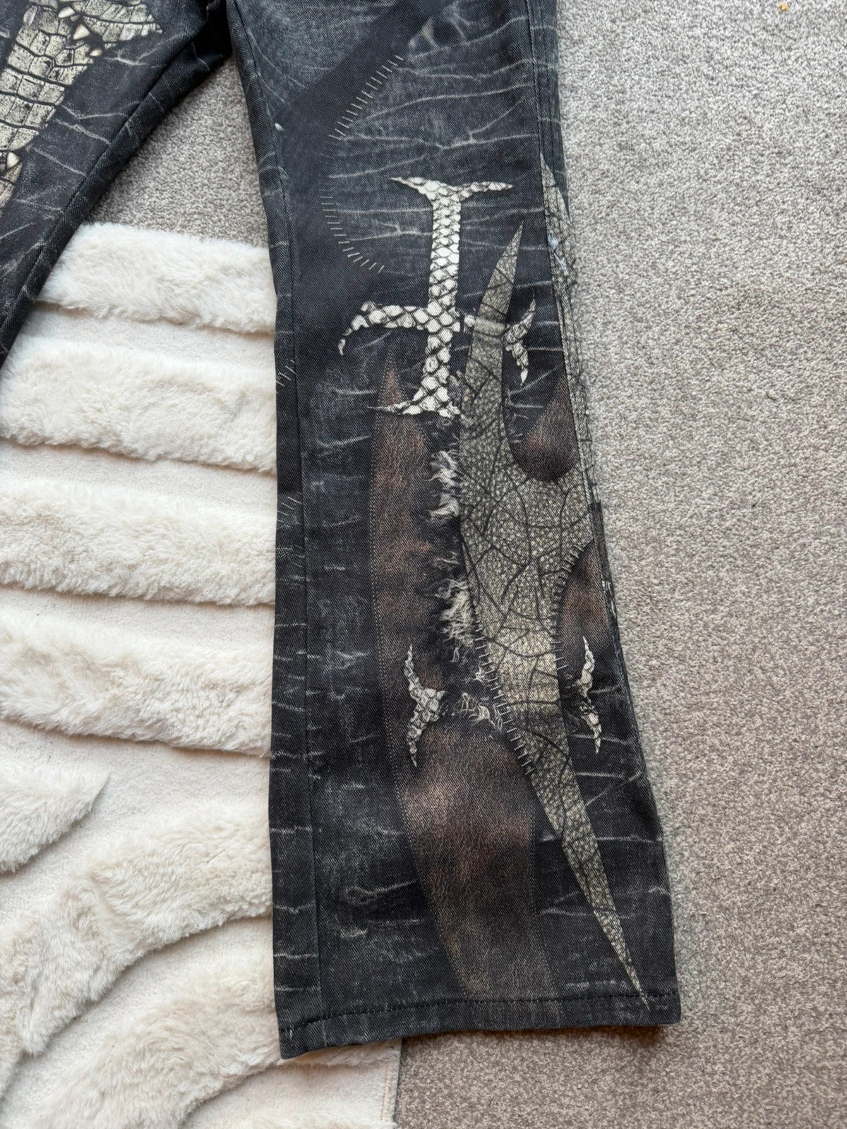 Vintage Denim black straight jeans with grey graphic print and wide leg style.