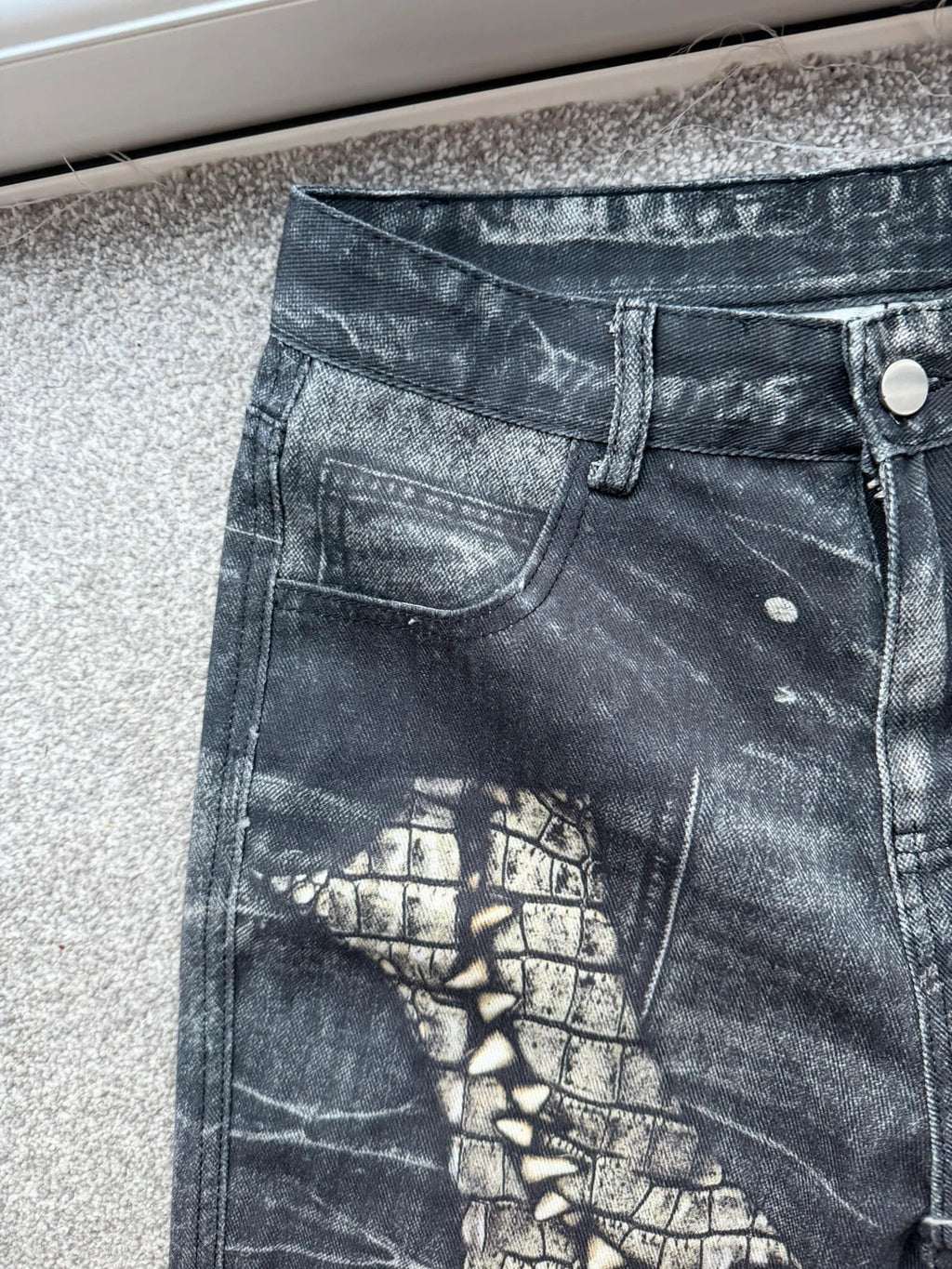 Vintage Denim black straight jeans with grey graphic print and wide leg style.