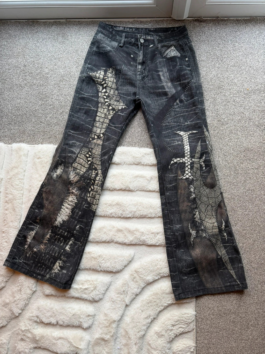 Vintage Denim black straight jeans with grey graphic print and wide leg style.
