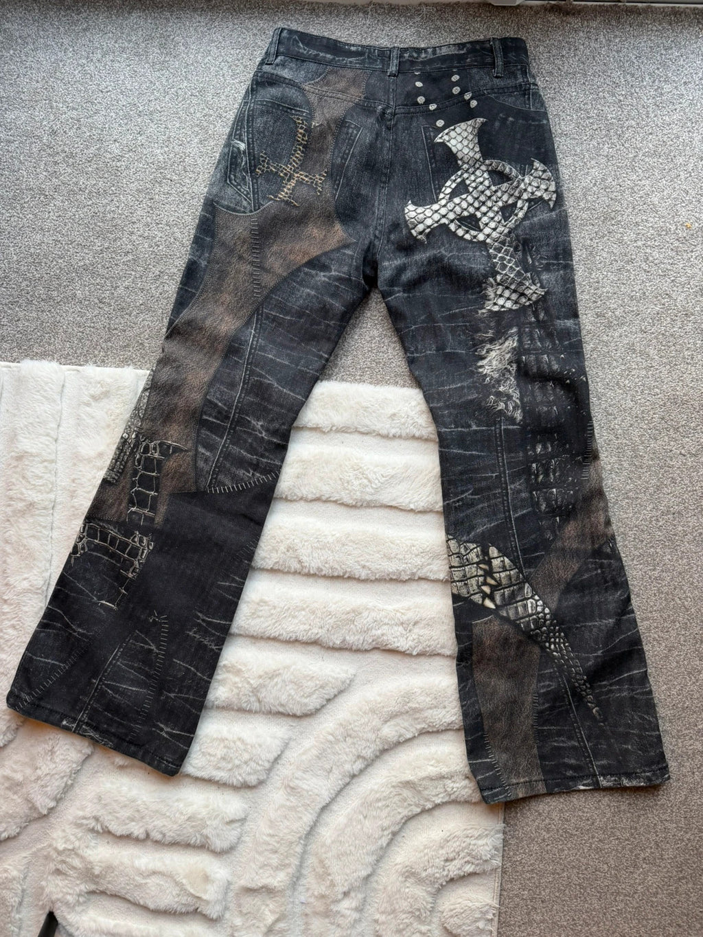 Vintage Denim black straight jeans with grey graphic print and wide leg style.