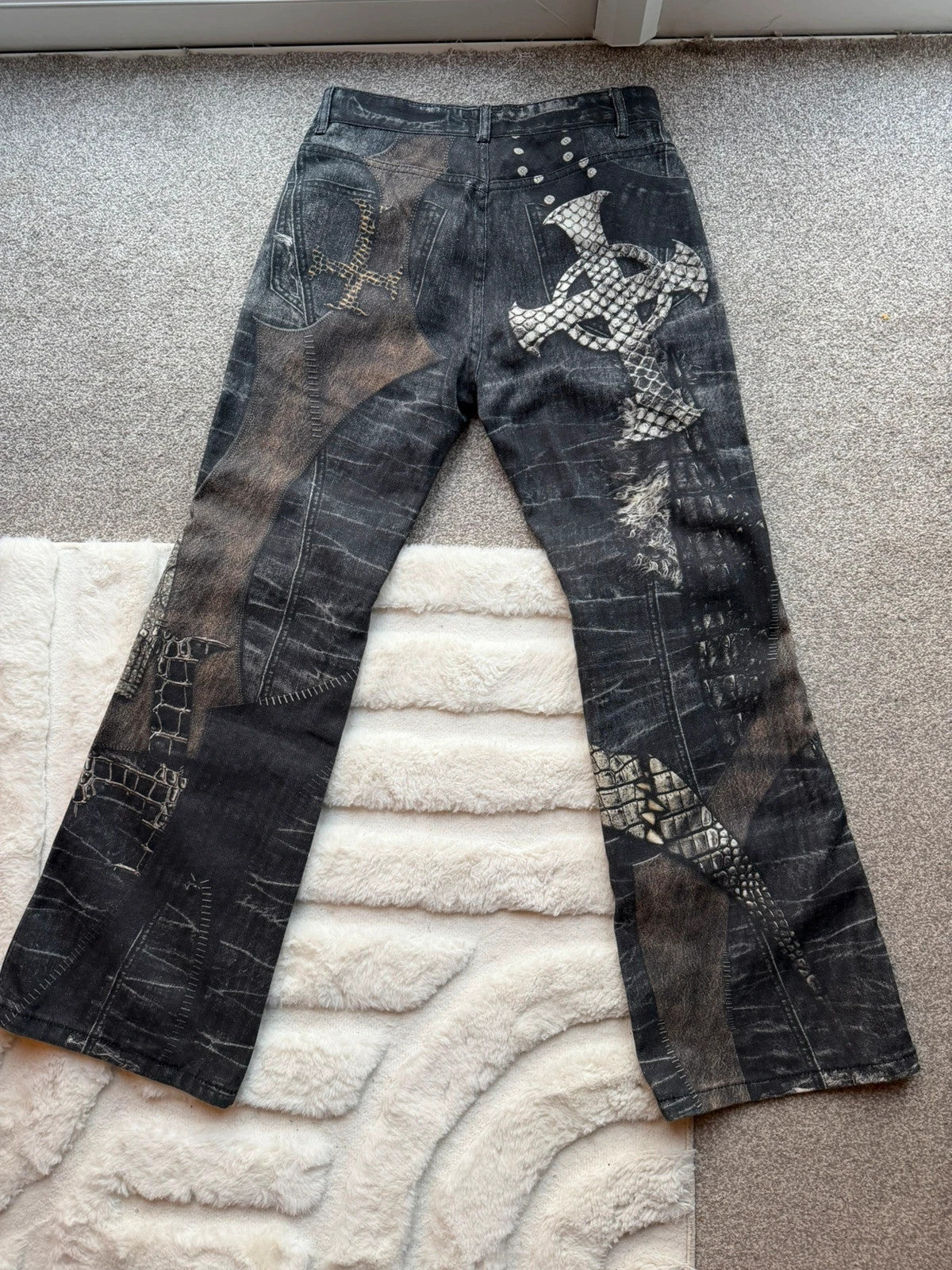 Vintage Denim black straight jeans with grey graphic print and wide leg style.