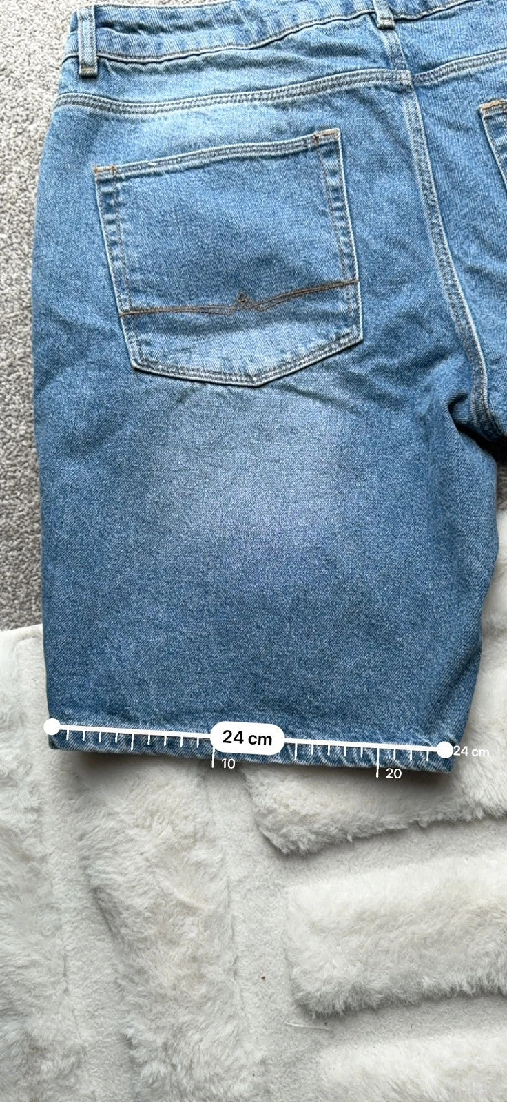 ASOS blue distressed denim shorts with frayed hem and casual Y2K style.