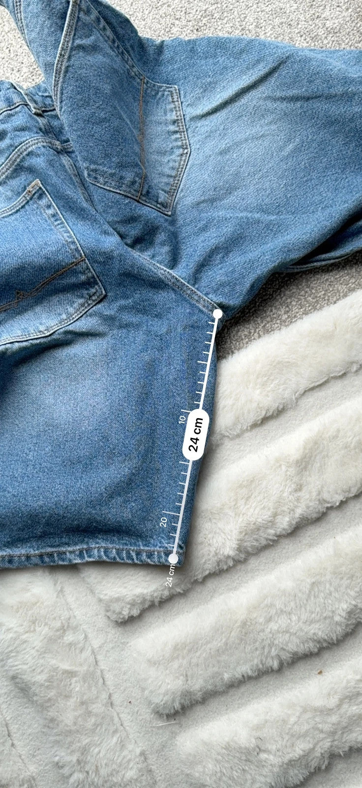 ASOS blue distressed denim shorts with frayed hem and casual Y2K style.