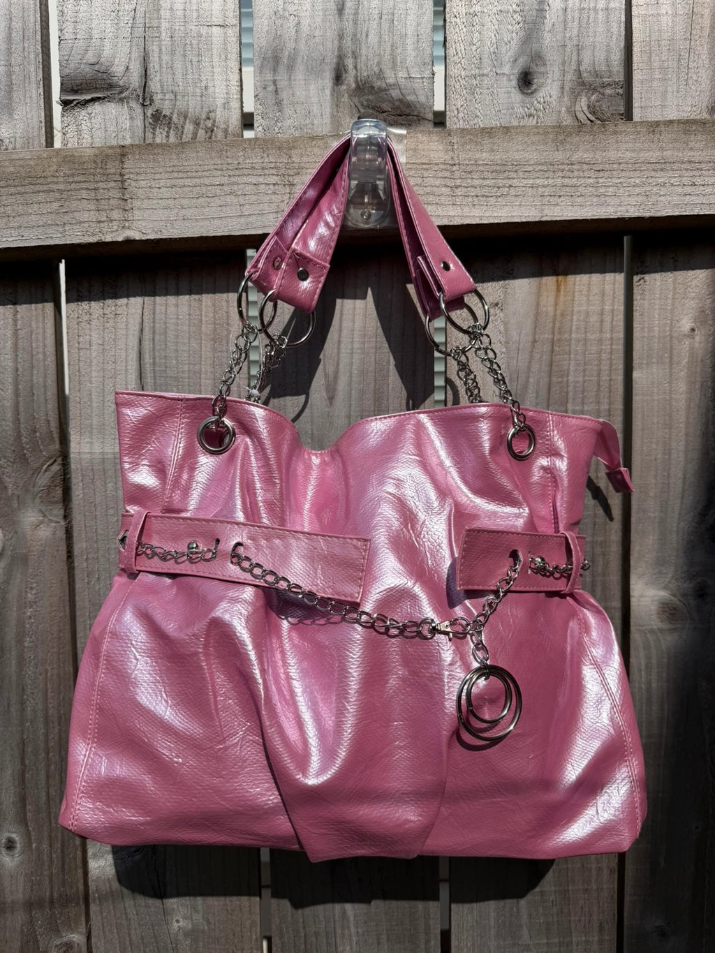 Vintage Dressing pink slouch shoulder bag with chain detail and large tote design.